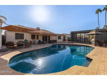 Inviting swimming pool with ample patio space for lounging and entertaining at 4348 E Sheena Dr, Phoenix, AZ 85032