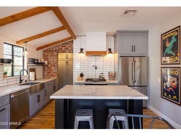 Modern kitchen with stainless steel appliances and marble countertops at 45 E Woodward Dr, Phoenix, AZ 85004