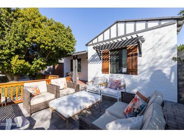 Inviting patio with wicker furniture and a coffee table at 45 E Woodward Dr, Phoenix, AZ 85004