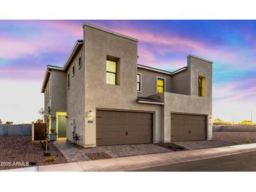 Two-story modern home with attached garage and desert landscaping at 4931 E Village Dr, Scottsdale, AZ 85254