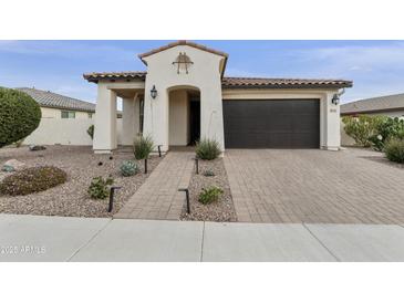 Single-story home with a dark brown garage door and landscaped front yard at 5715 S Winchester --, Mesa, AZ 85212