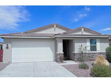 One-story house with white garage door and stone accents at 7284 E Gamebird Way, San Tan Valley, AZ 85143