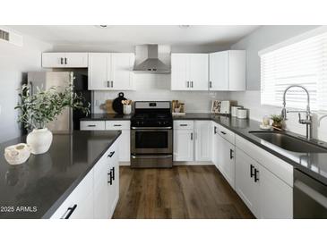 Modern kitchen with white cabinets, stainless steel appliances, and a large island at 7301 E Almeria Rd, Scottsdale, AZ 85257