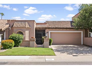 Spanish style home with tile roof, two-car garage, and well-manicured lawn at 7729 N Via De Fonda --, Scottsdale, AZ 85258