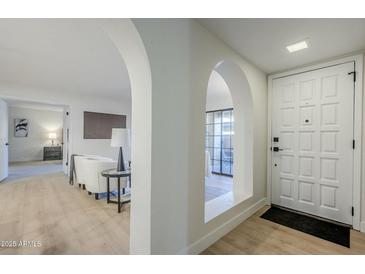 Bright entryway with arched hallways and white door at 10410 N Cave Creek Rd # 1220, Phoenix, AZ 85020