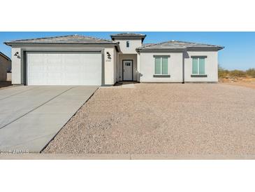 New single-story home with a two-car garage and gravel landscaping at 12360 W Delwood Dr, Arizona City, AZ 85123