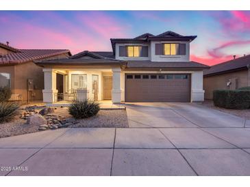 Two-story house with a two-car garage and landscaped front yard at 12409 W Montebello Ave, Litchfield Park, AZ 85340