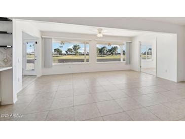 Spacious dining area with large windows and golf course view at 17635 N Buntline Dr, Sun City West, AZ 85375