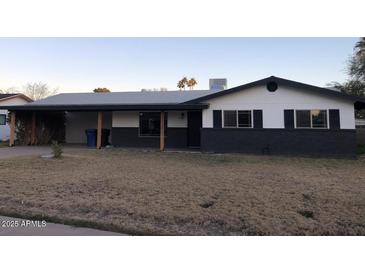 Updated single-level home with modern exterior and landscaping at 1839 E Indigo St, Mesa, AZ 85203