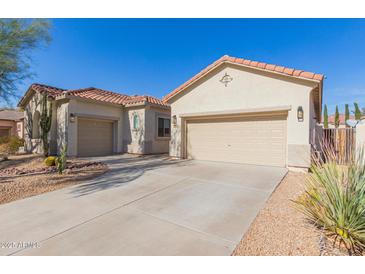 Two-car garage, desert landscaping, and neutral-colored exterior at 2410 W Aloe Vera Dr, Phoenix, AZ 85085