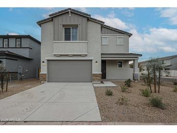 Two-story home with gray siding, two-car garage, and landscaped yard at 2575 E Bluff Spring Ave, Apache Junction, AZ 85119