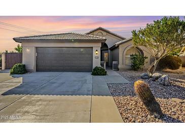 Single-story home with a two-car garage and desert landscaping at 2930 N 154Th Dr, Goodyear, AZ 85395