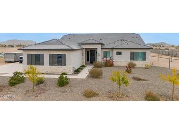 Single-story home with gray roof and landscaped yard at 3588 W New Life Ln, Queen Creek, AZ 85144