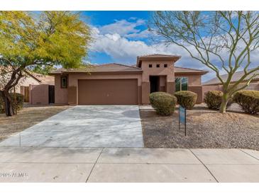 Single-story home with a two-car garage and landscaped front yard at 3663 S Hassett --, Mesa, AZ 85212