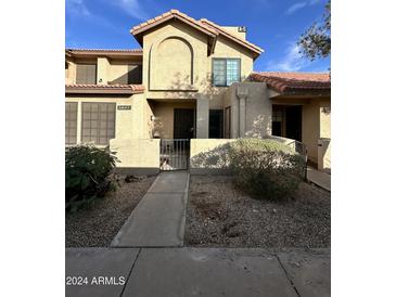 Two-story townhome with Spanish-style architecture and gated entry at 8625 E Belleview Pl # 1047, Scottsdale, AZ 85257