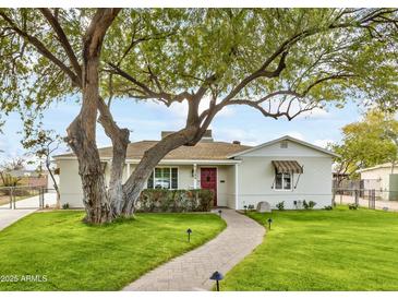 Charming bungalow with mature trees, landscaped lawn, and brick walkway at 1727 W Flower St, Phoenix, AZ 85015