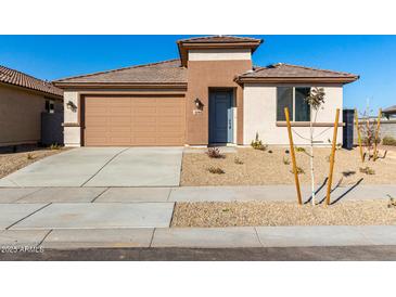 Single-story home with a two-car garage and desert landscaping at 18398 W Monte Lindo Ln, Surprise, AZ 85387