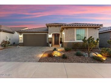 Single-story home with brown garage door and landscaped yard at 27453 W Wahalla Ln, Buckeye, AZ 85396