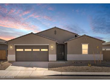 Charming single-story home featuring a two-car garage and low-maintenance desert landscaping at 37073 W La Paz St, Maricopa, AZ 85138