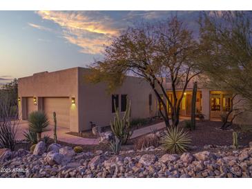 Desert landscape surrounds this stucco home with a three-car garage at 44710 N 18Th St, New River, AZ 85087