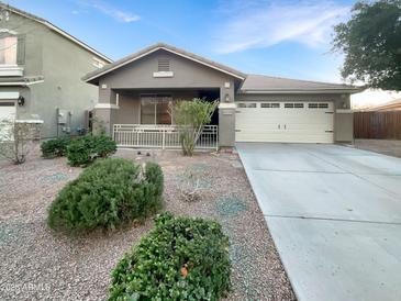 Single-story house with a two-car garage and well-maintained landscaping at 6038 S Connie Ln, Gilbert, AZ 85298