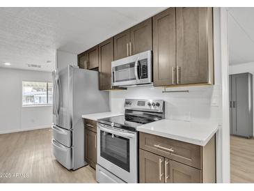Modern kitchen with stainless steel appliances and quartz countertops at 7648 E Holmes Ave, Mesa, AZ 85209