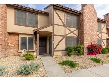 Brick townhouse exterior with landscaping and walkway at 7905 W Thunderbird Rd # 309, Peoria, AZ 85381