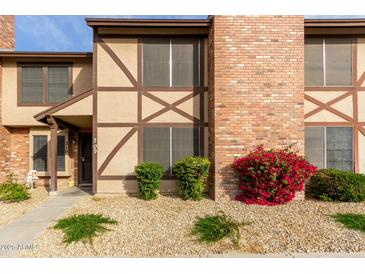 Brick townhouse exterior with landscaping and walkway at 7905 W Thunderbird Rd # 309, Peoria, AZ 85381