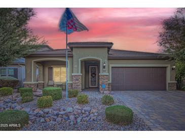 One-story home with a brown garage door and landscaped front yard at 11047 E Tupelo Ave, Mesa, AZ 85212