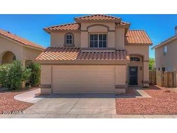 Two-story house with a tile roof and attached garage at 1231 E Helena Dr, Phoenix, AZ 85022