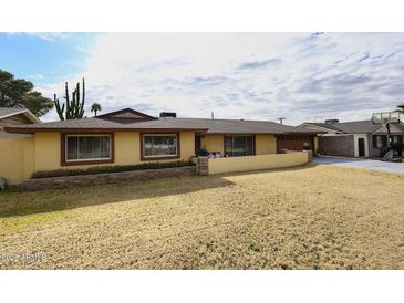 Ranch style home with large yard, mature trees, and two-car garage at 1707 E Mclellan Blvd, Phoenix, AZ 85016