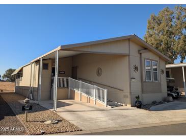 Tan mobile home with carport and ramp access at 17200 W Bell Rd # 1599, Surprise, AZ 85374