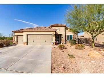 Single-story house with three-car garage and desert landscaping at 17502 W Blue Sky Dr, Surprise, AZ 85387