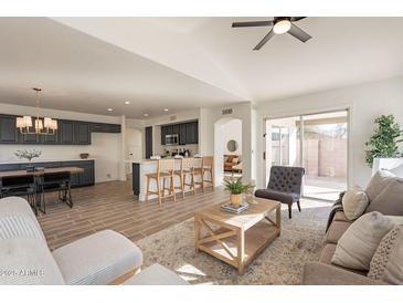 Open concept kitchen and living area with modern finishes and island at 18204 N 11Th Dr, Phoenix, AZ 85023