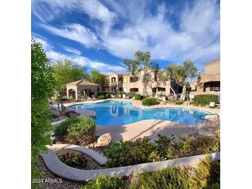 Relaxing resort-style pool with lush landscaping at 19475 N Grayhawk Dr # 2169, Scottsdale, AZ 85255