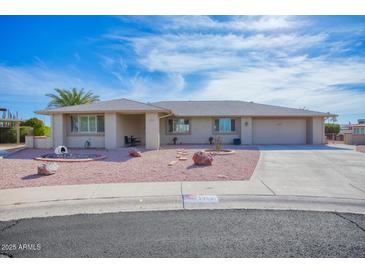 Single-story home with desert landscaping and a two-car garage at 19607 N Conquistador Dr, Sun City West, AZ 85375