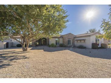 Single-story home with stone accents and a landscaped yard at 24435 S 195Th St, Queen Creek, AZ 85142