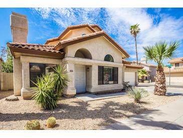 Attractive single-story home with desert landscaping and a tile roof at 4407 E Villa Theresa Dr, Phoenix, AZ 85032