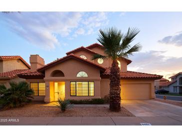 Two-story house with Spanish-style architecture and a landscaped front yard at 4407 E Villa Theresa Dr, Phoenix, AZ 85032