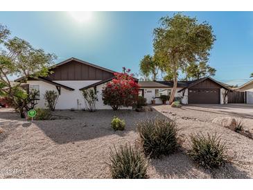 Charming single story home with landscaped front yard and large driveway at 6409 W Orange Dr, Glendale, AZ 85301