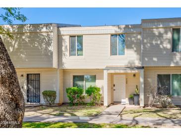 Updated exterior of charming townhome, featuring a welcoming front entrance and landscaping at 725 E Vaughn Dr, Tempe, AZ 85283