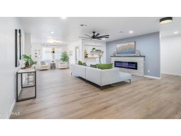 Spacious living area with hardwood floors and a modern fireplace at 7749 E Coolidge St, Scottsdale, AZ 85251