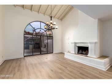 Bright dining room features a fireplace and large arched window at 8438 N 84Th Pl, Scottsdale, AZ 85258