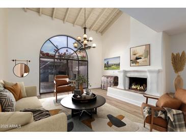 Living room boasts a fireplace and stylish furniture at 8438 N 84Th Pl, Scottsdale, AZ 85258