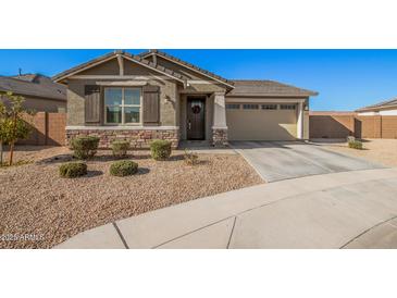 One-story home with stone accents and a two-car garage at 9316 S 39Th Dr, Laveen, AZ 85339