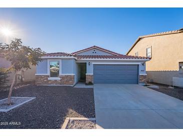 Single-story home with gray garage door and stone accents at 1033 E Leslie Ave, San Tan Valley, AZ 85140