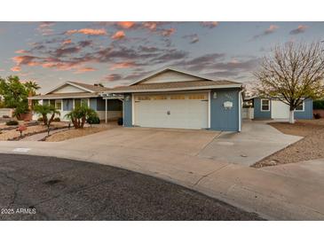 Two-car garage and nicely landscaped front yard at 10611 W Caron Dr, Sun City, AZ 85351