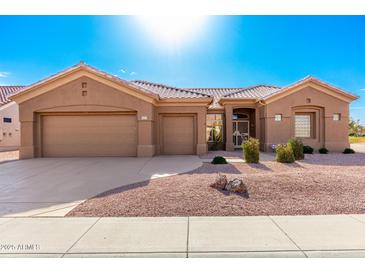 Single-story home with a two-car garage and desert landscaping at 14233 W Via Montoya --, Sun City West, AZ 85375