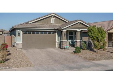 Single-story home with a two-car garage and landscaped front yard at 15282 W Mckinley St, Goodyear, AZ 85338