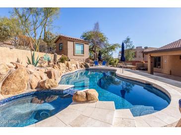 Inviting pool and spa surrounded by rocks and a private casita at 15708 E Chicory Dr, Fountain Hills, AZ 85268